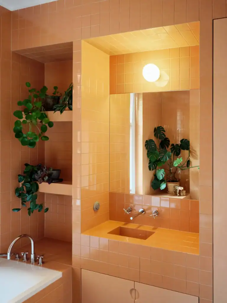 Colorful ceramic bathroom tiles with built-in plant shelves and modern lighting.